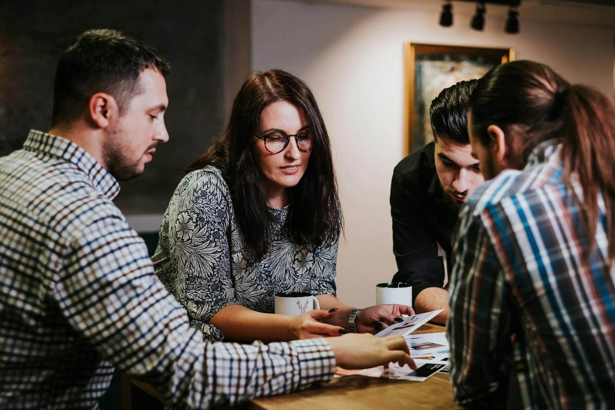 Equipo de una pequeña empresa reunido alrededor de una mesa