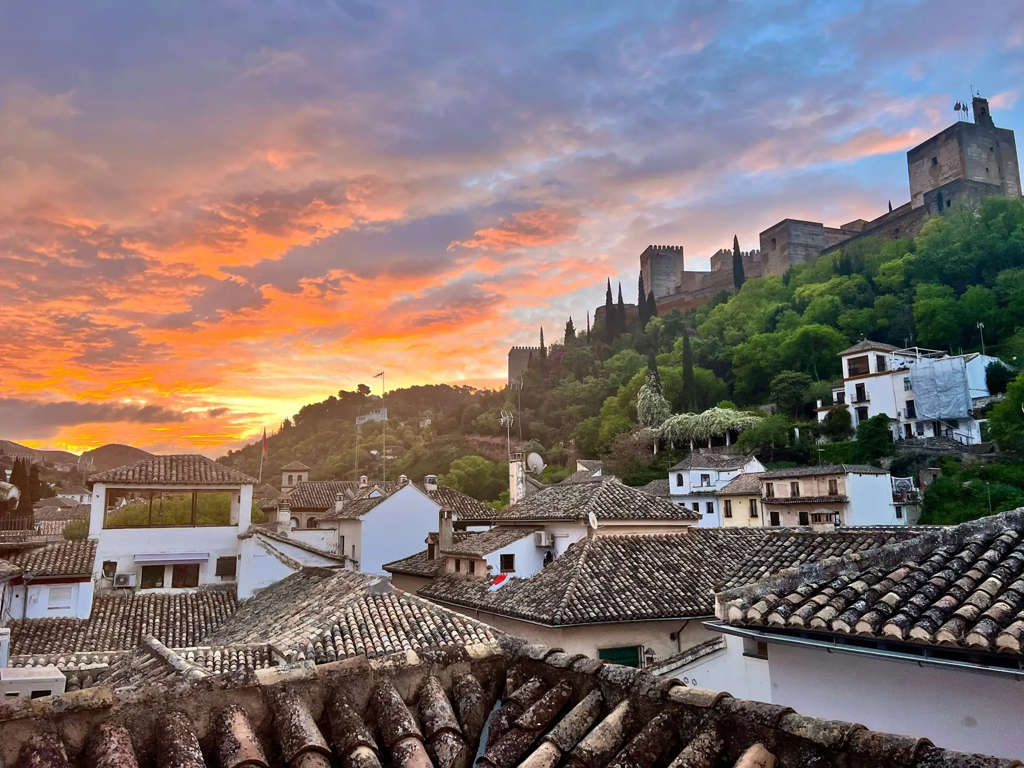 La Alhambra sobre las casas blancas de Granada al atardecer